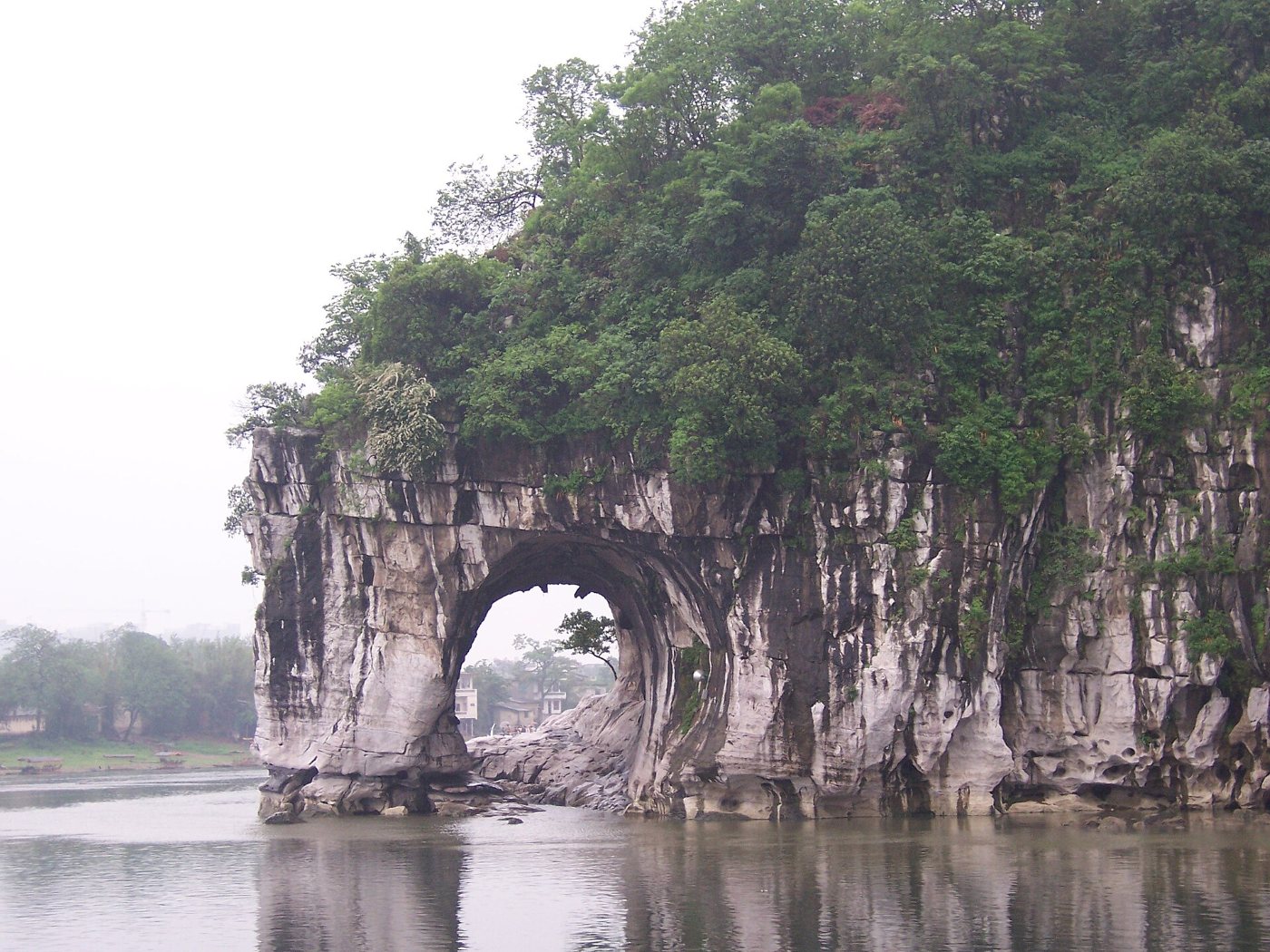 Elephant Trunk Hill in Guilin: a limestone rock with an arch over the Li River, reflected in the calm water