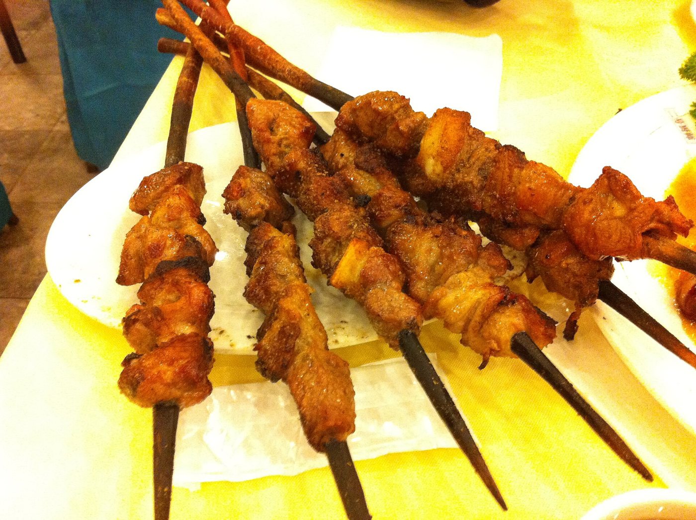 Lamb skewers on wooden sticks, seasoned with cumin and chilli