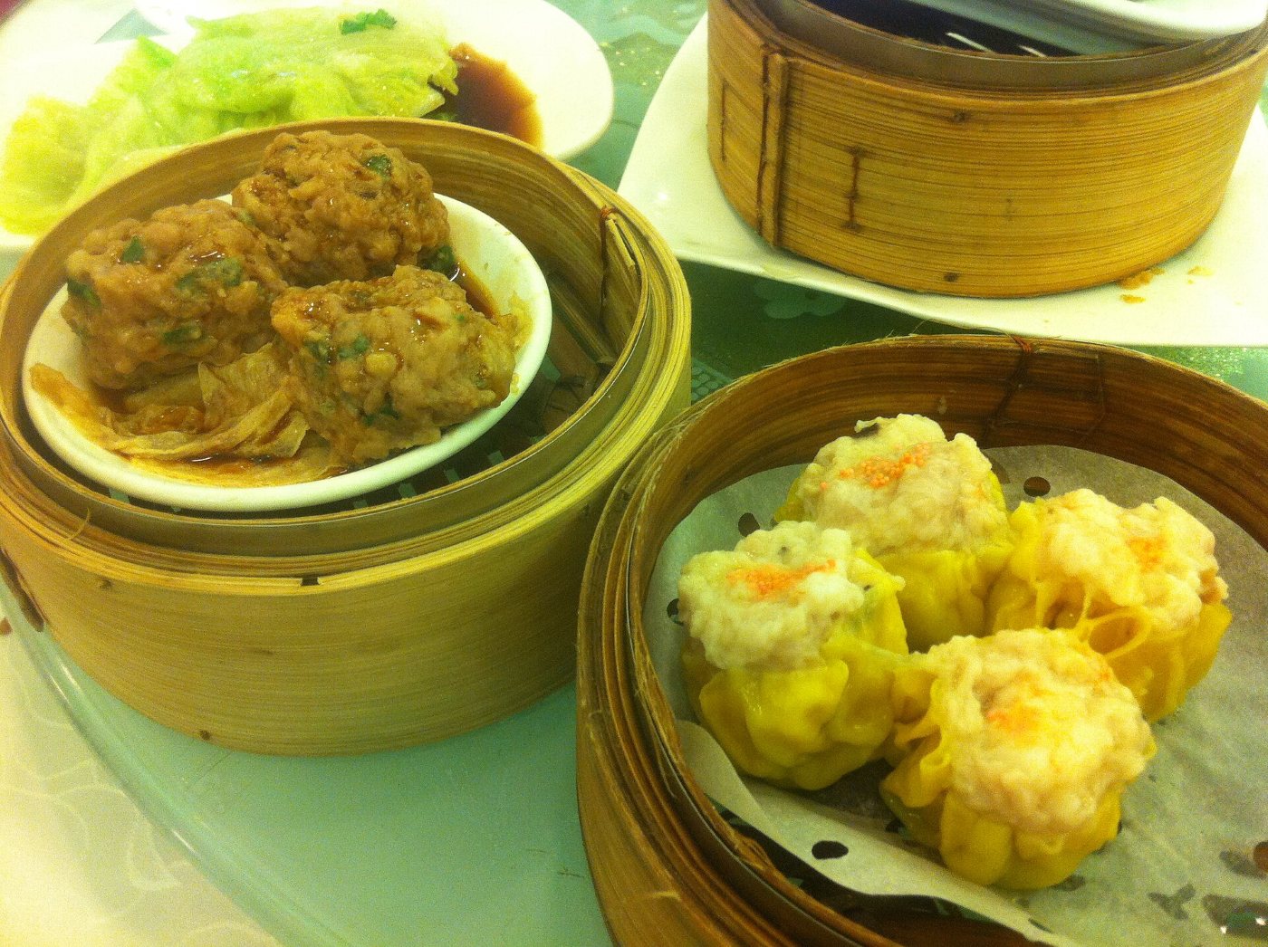 Bamboo steamers of dim sum: siu mai dumplings and beef balls