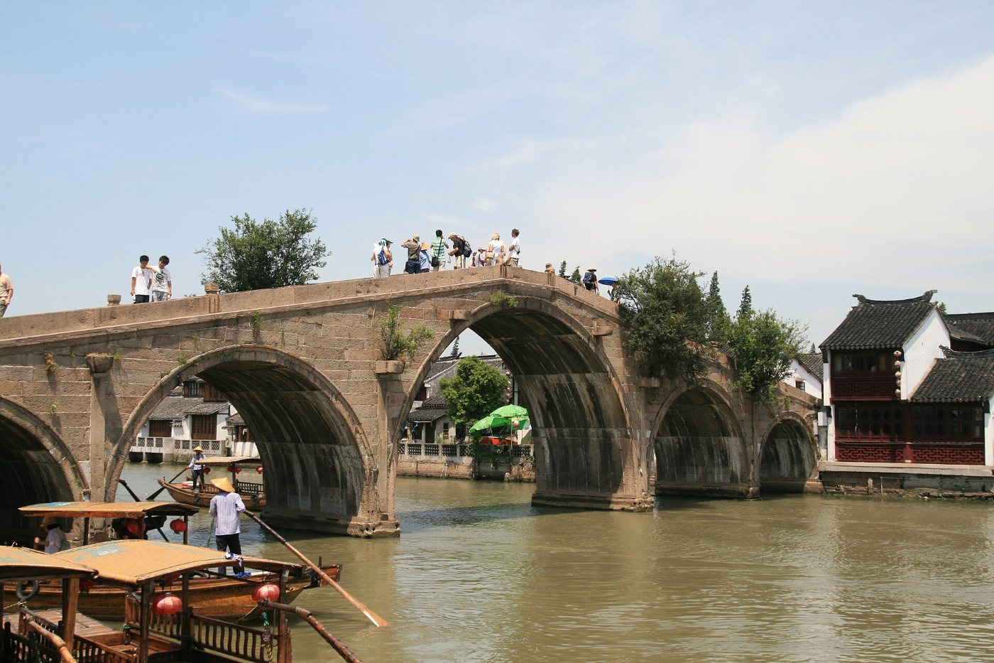 The five-arched stone Fangsheng Bridge over a canal in Zhujiajiao, with boats on the water